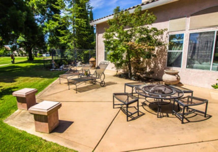 Concrete Patio outside the house with chairs in Raleigh